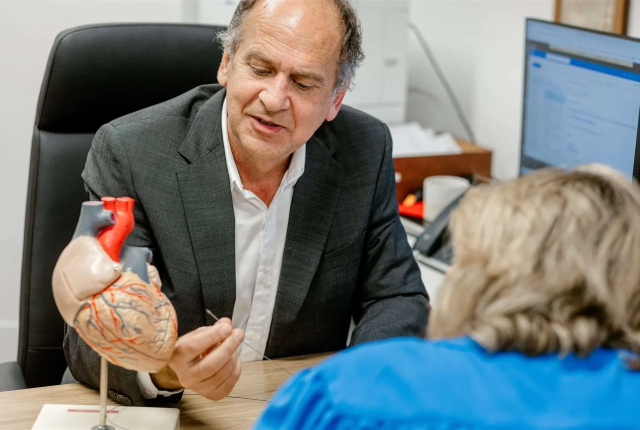 Dr Peter Hadjipetrou explaining details of the human heart to a patient during a consultation