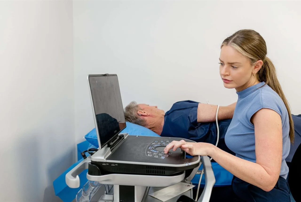A nurse conducting a heart test