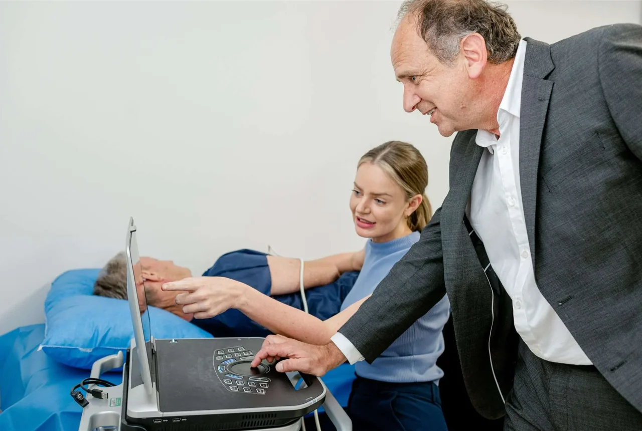 Dr Hadjipetrou looking at a computer screen while a patient is undergoing a heart test
