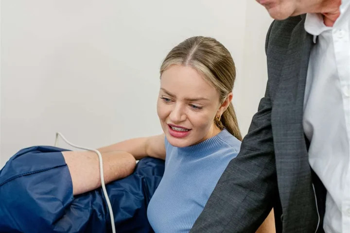 Dr Hadjipetrou looking at a computer screen while a patient is undergoing a heart test