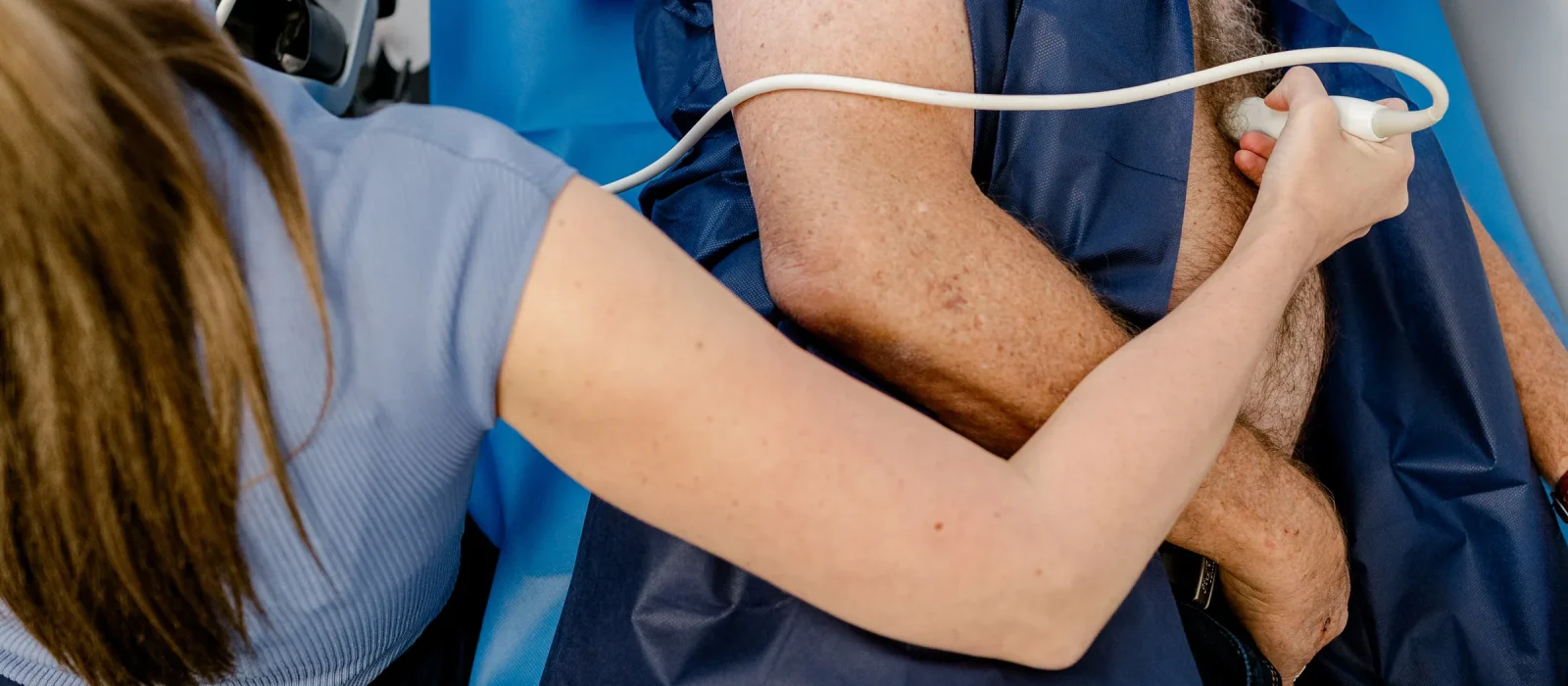 Details of the clinic manager conduction a heart's test on a patient