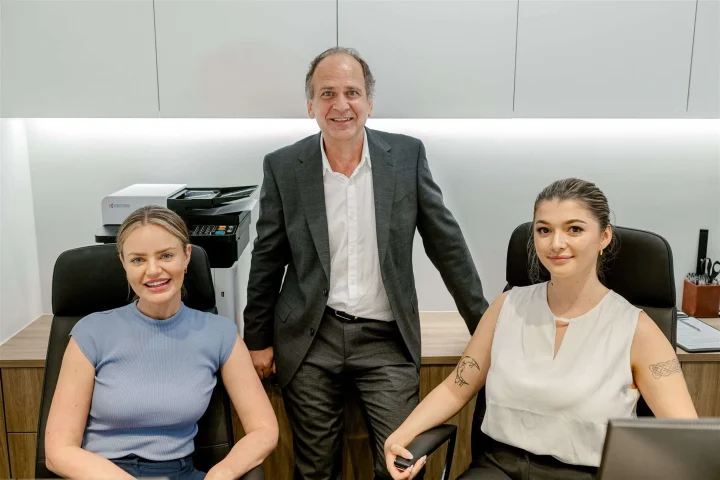Hadjipetrou Cardiology - Team members posing at the clinic's desk