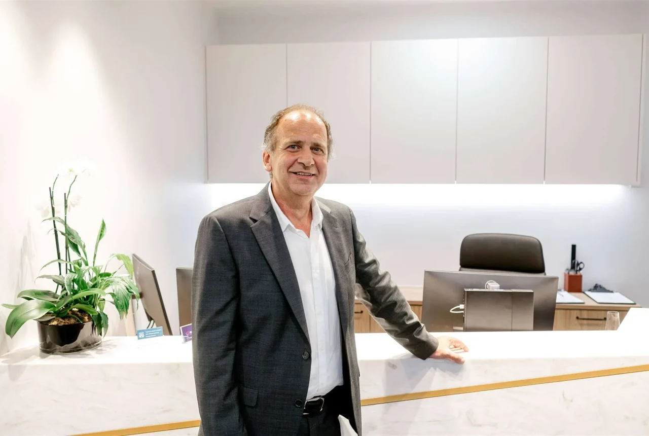 Dr Peter Hadjipetrou posing at the clinic's front desk